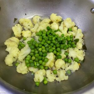 adding peas to the cauliflower