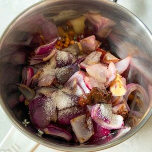 sauteed onions along with tamarind and salt in mixer jar