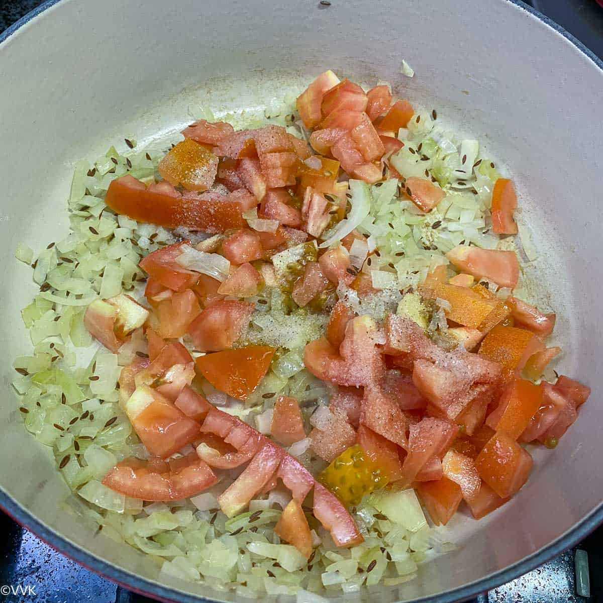 adding tomatoes and salt