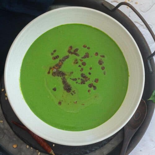 square image of spinach raita in a white bowl