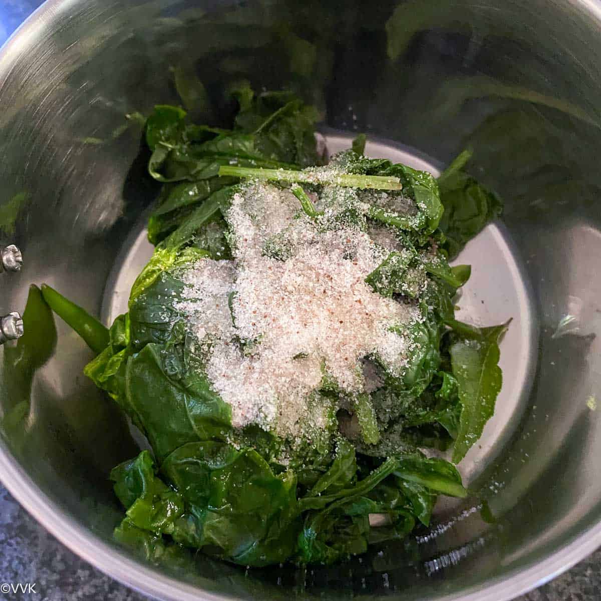 adding the spinach and salt into the mixer jar