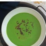 spinach raita topped with tempering placed on a white bowl with text overlay for pinterest