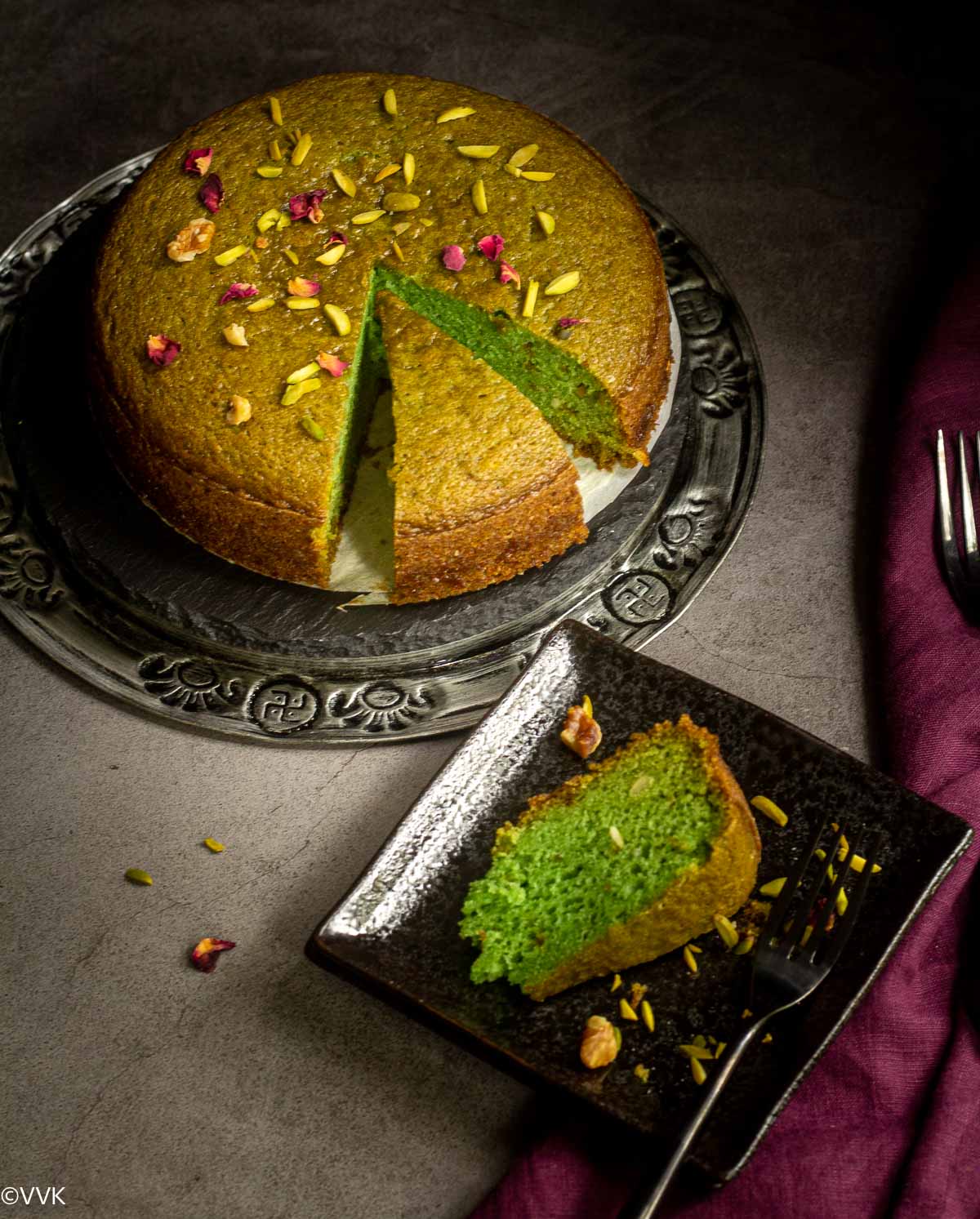 vegan paan cake served on a plate with a slice cut