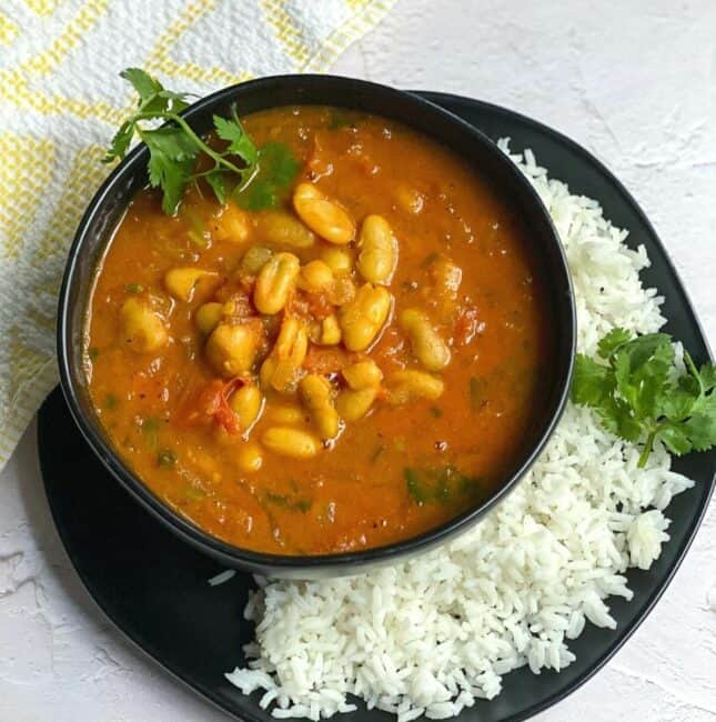 moroccan bean stew served in black bowl with rice