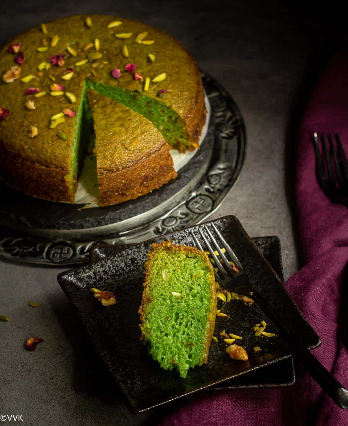 vegan paan cake served on a plate with a slice cut