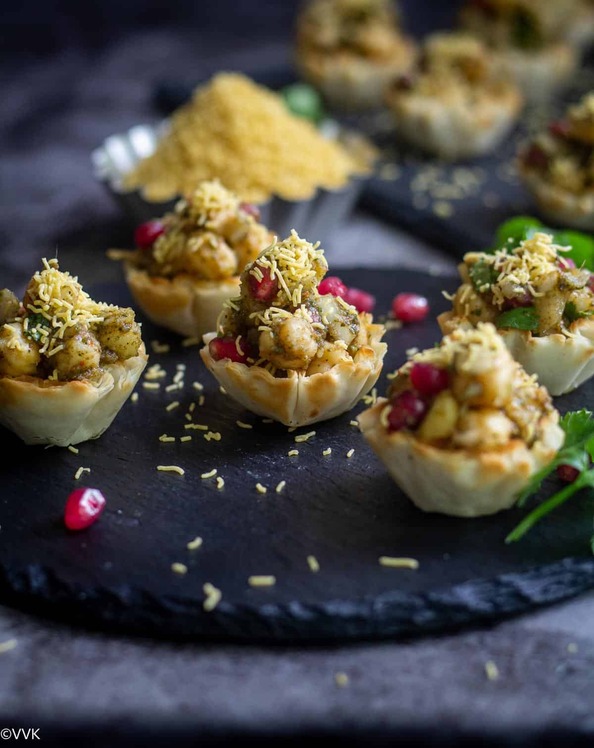 angled close up shot of aloo chana chaat placed in phyllo shell