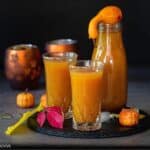 square image of pumpkin juice served in two glasses and in one bottle