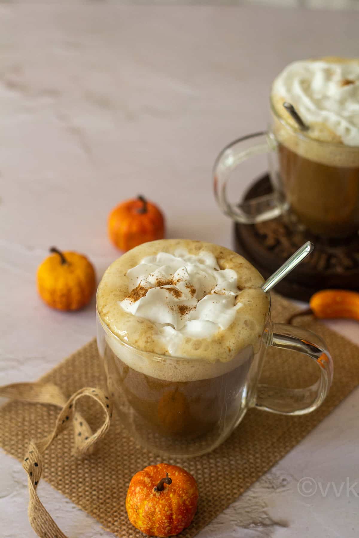 vegan pumpkin spice latte served in a glass placed on a burlap cloth