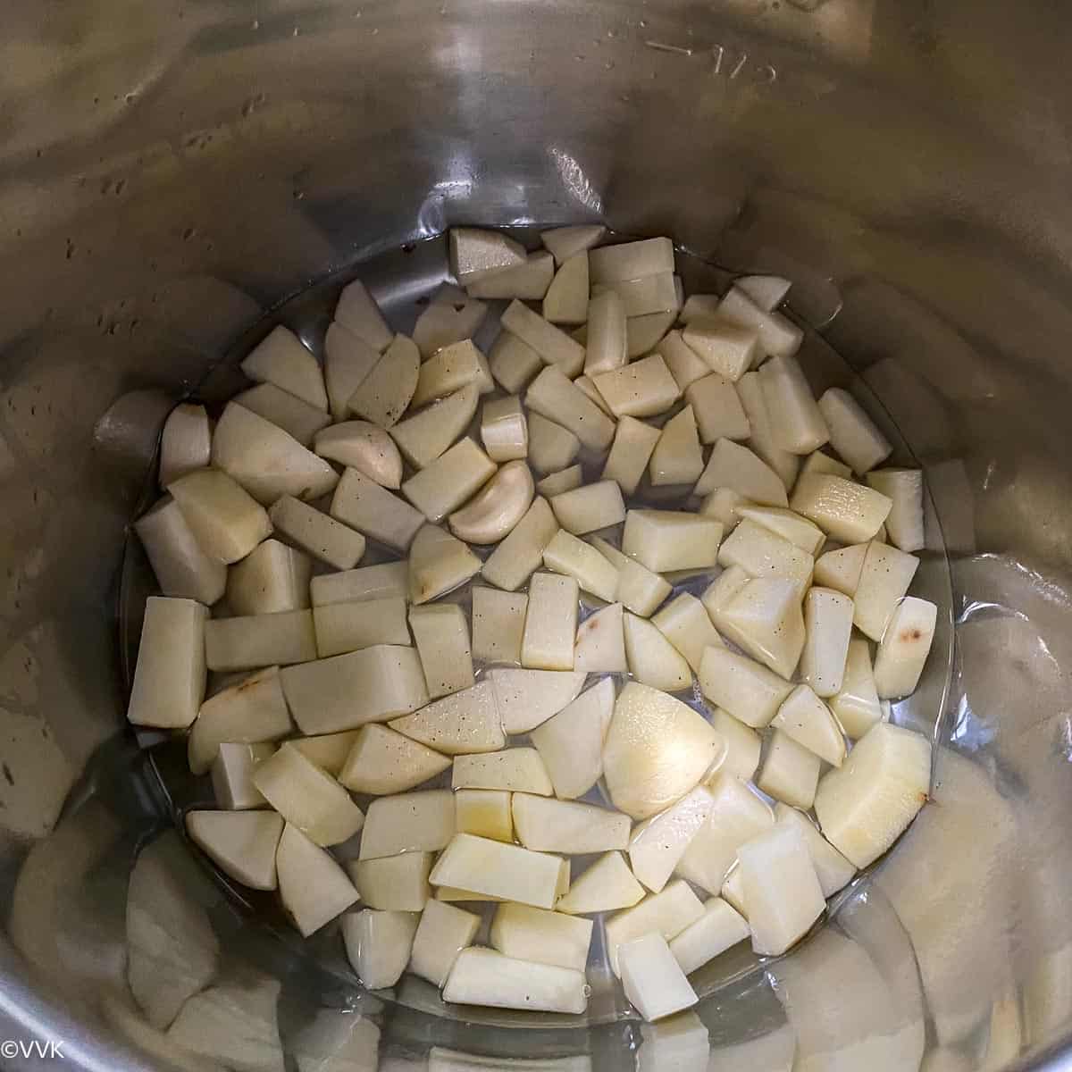 adding the chopped potatoes and garlic in the IP