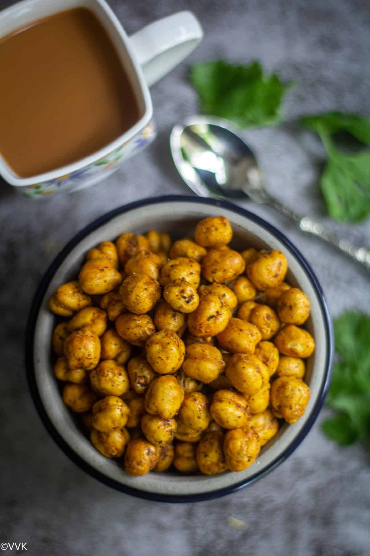 overhead shot of roasted chickpeas in a bowl served with tea