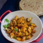 roasted cauliflower and potatoes with roti with text overlay for pinterest