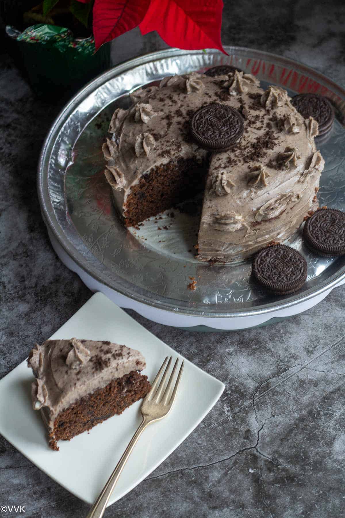 oreo cake served in silver tray and with one slice on the plate
