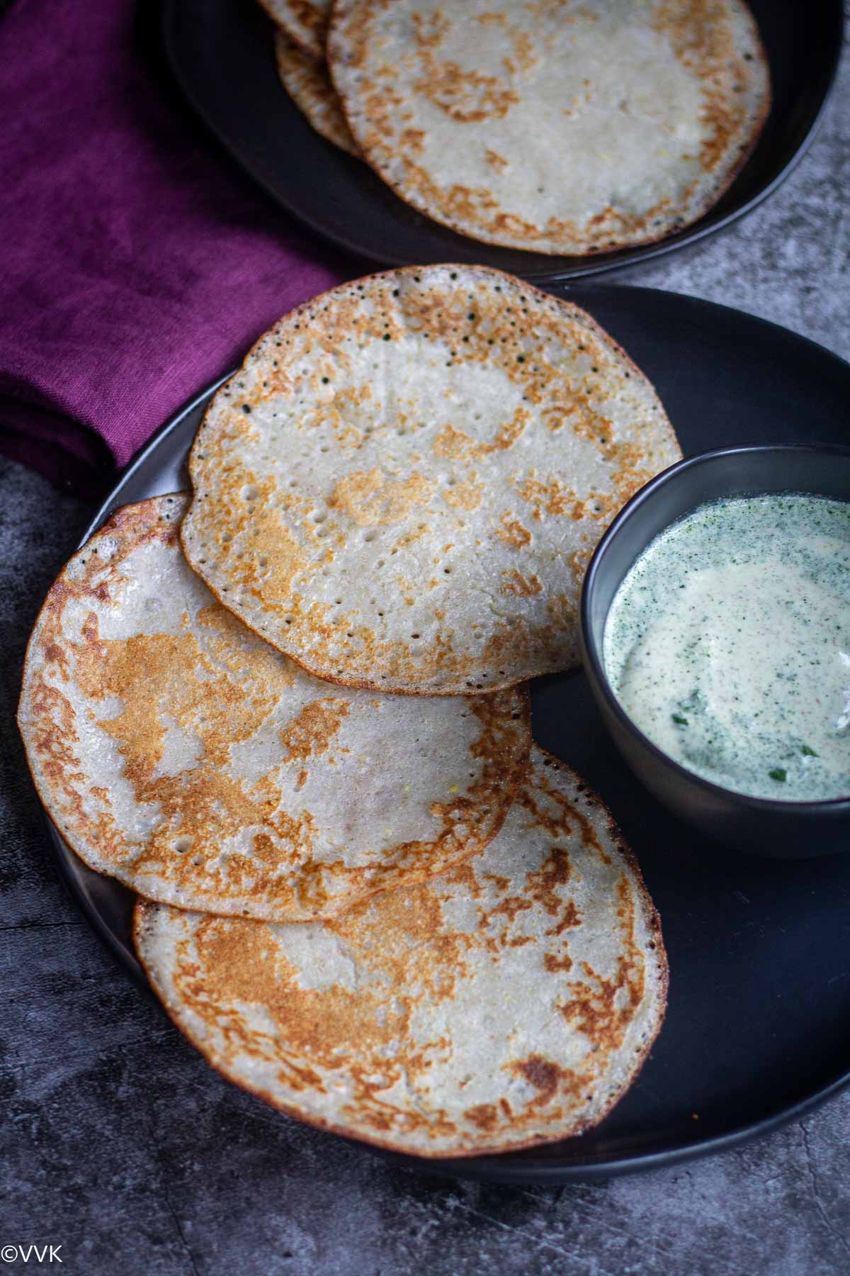 kuttu ki dosa with farali chutney served in black plate and bowl