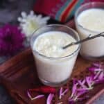 rice kheer served in single serving glass jars with flowers on the side