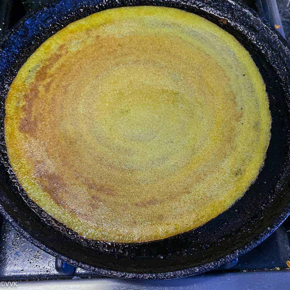 flipping the dosa and cooking again
