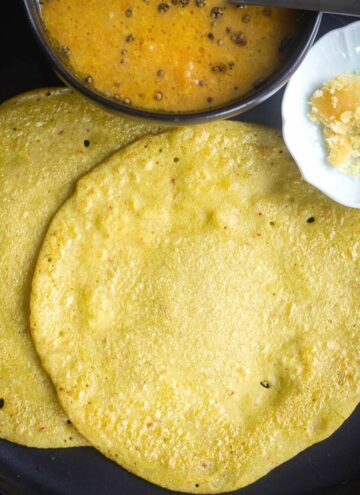 square image of edamame dosa served with jaggery and sambar