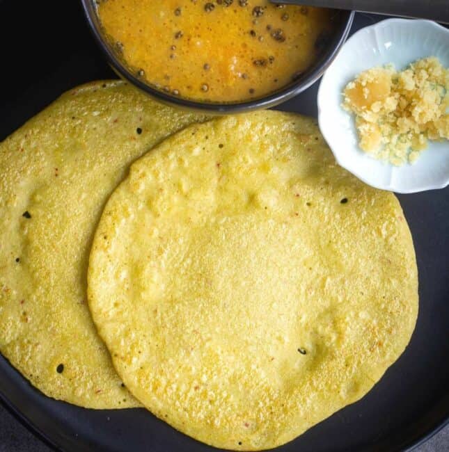 square image of edamame dosa served with jaggery and sambar