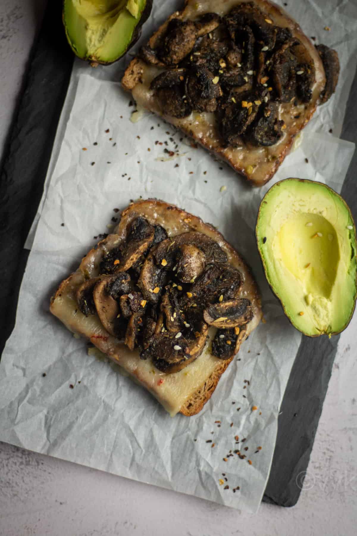 overhead shot of toast with mushrooms served with avocado