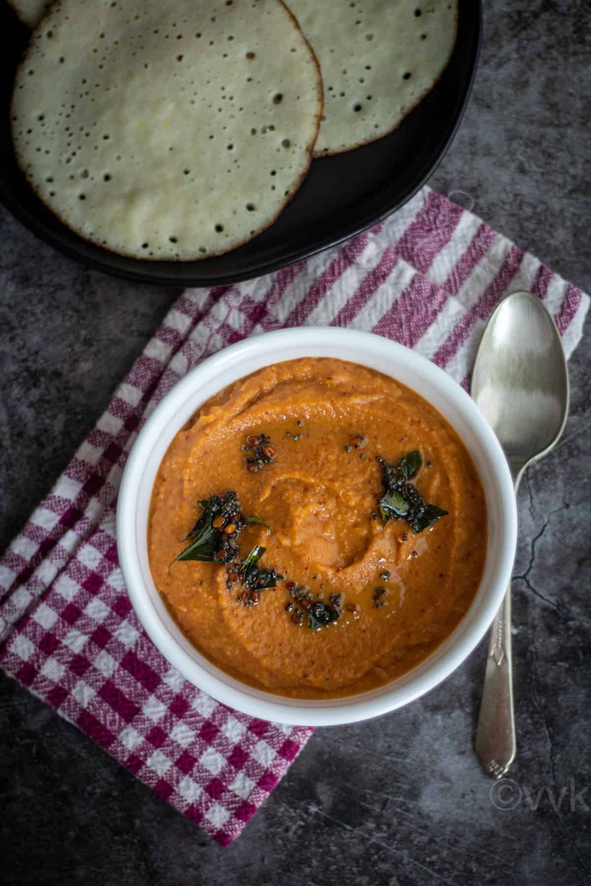 overhead shot of onion chutney served with aval dosa