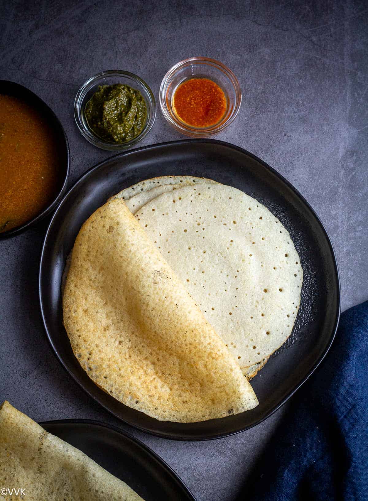 overhead shot of soft idli rava dosa served with assorted sides
