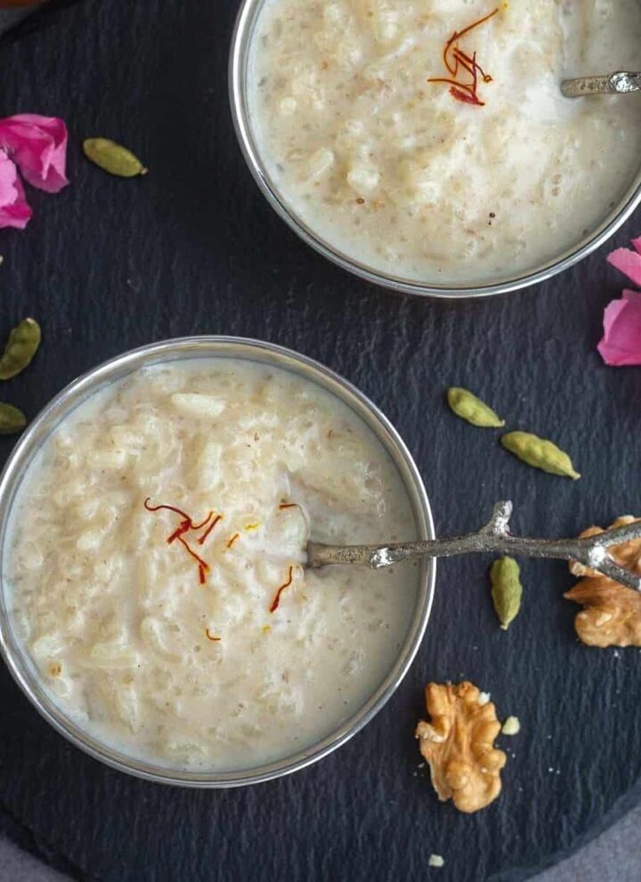 square image of instant pot walnut kheer served in two bowls placed on black slate board
