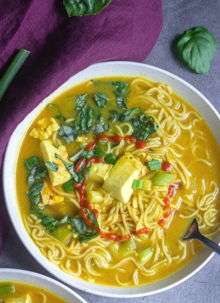 overhead shot of vegan miso ramen soup served in white bowl
