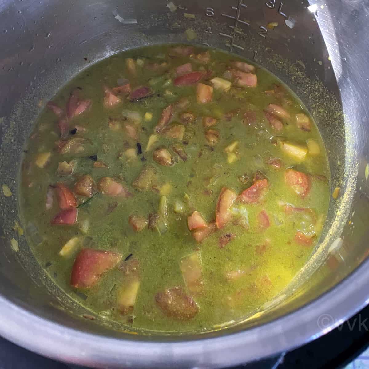 add the water to the tomato green masala mix