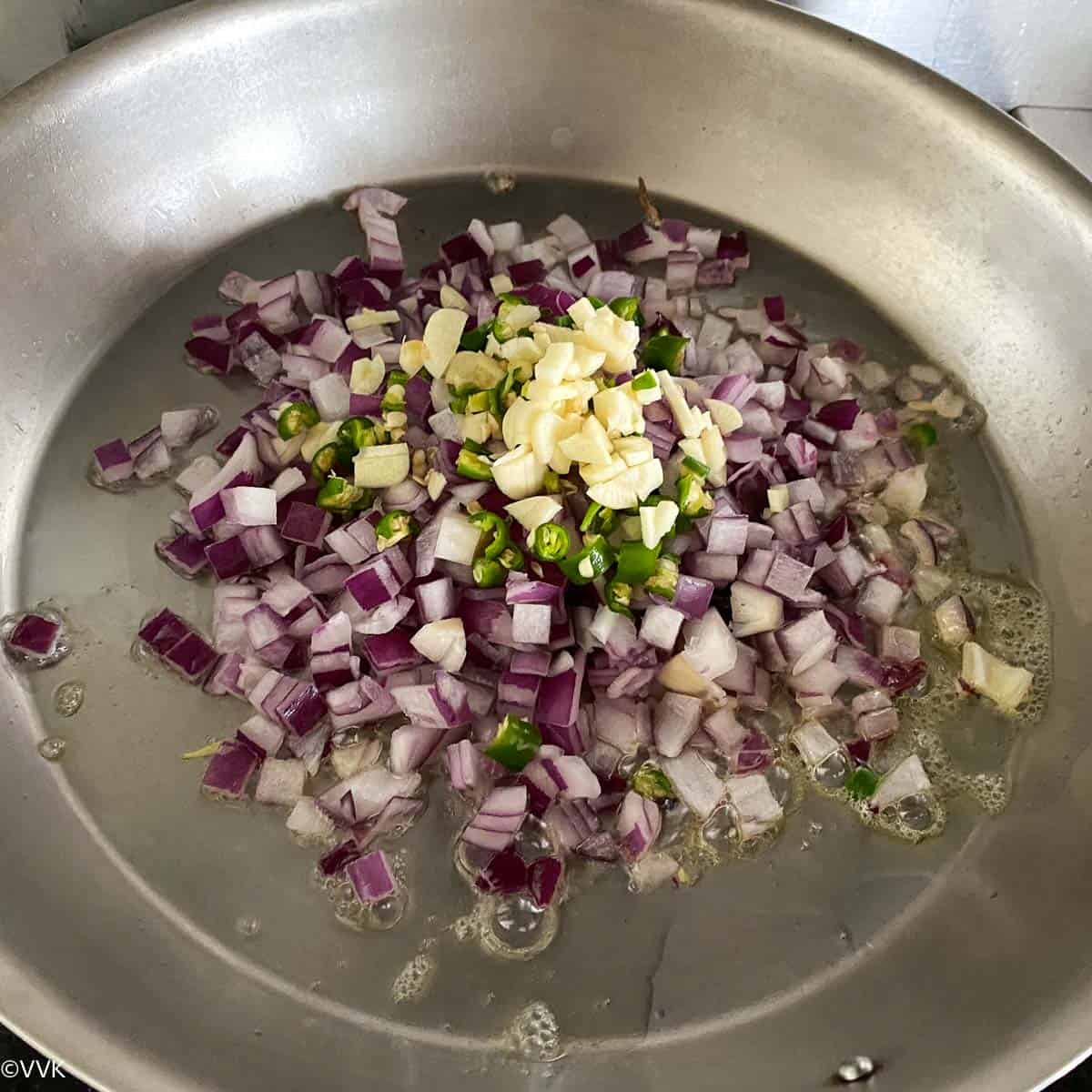 sauteing onions, garlic and green chilies