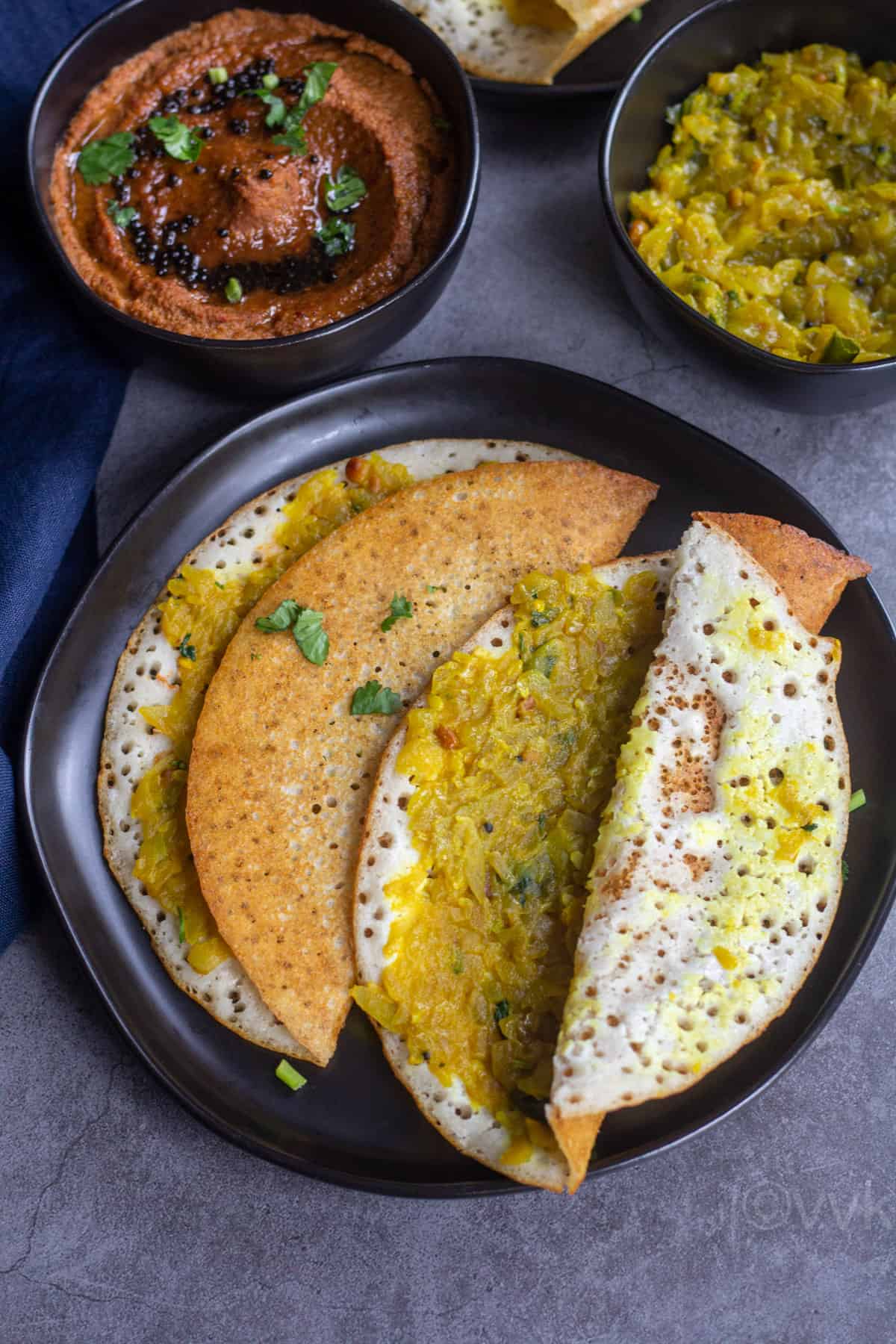 sorakkai masala dosa with one dosa opened up to show the stuffing served with chutney