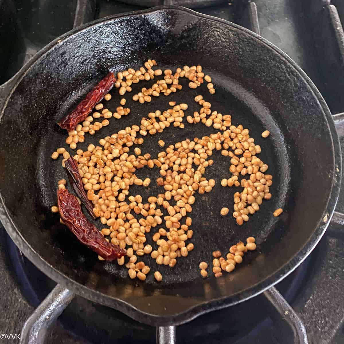 roasting urad dal and chilies for the chutney