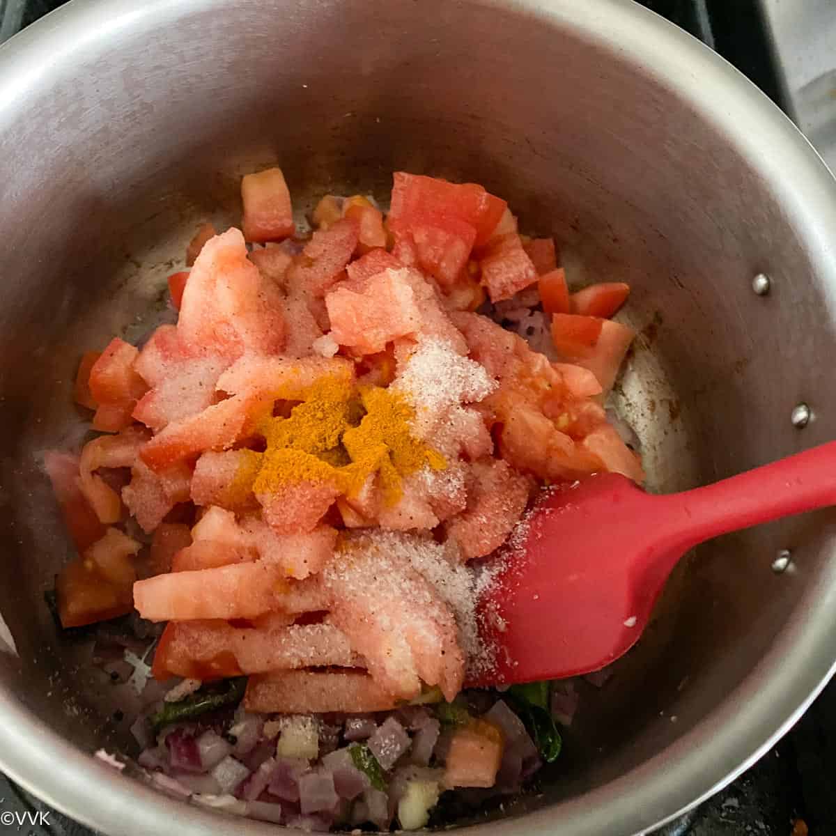 adding the chopped tomatoes and cooking
