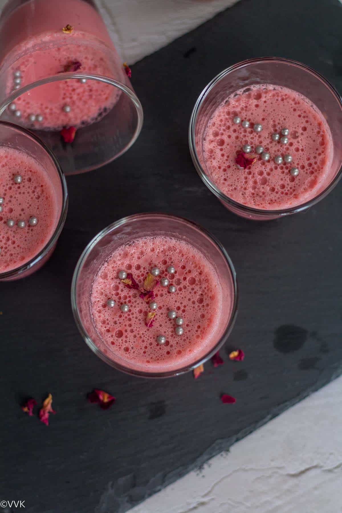 creamy rose panna cotta served in single serve glasses placed on black board