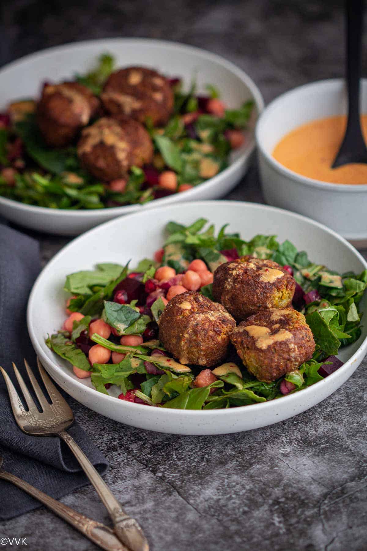 falafel salad served in two bowls with homemade yogurt dressing