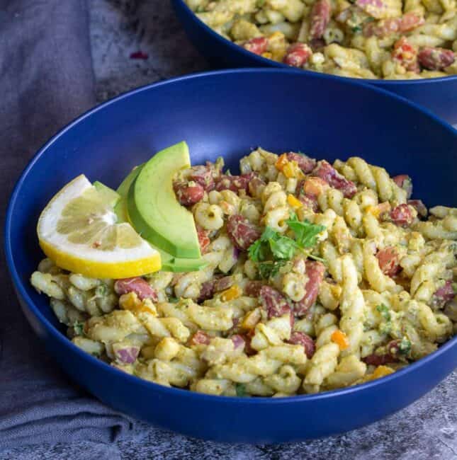 square image of taco pasta salad served in blue bowl