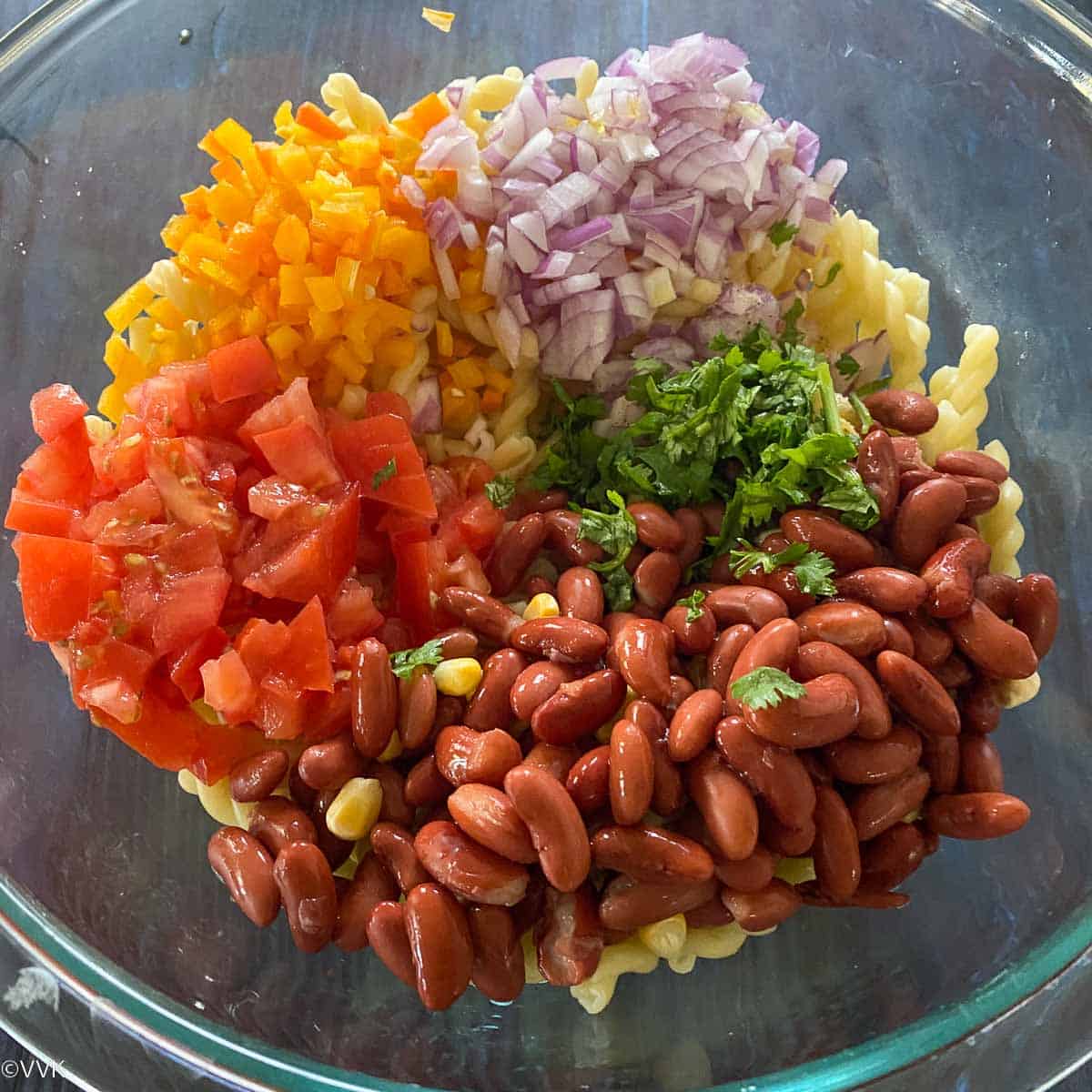 adding ingredients for the salad in a bowl