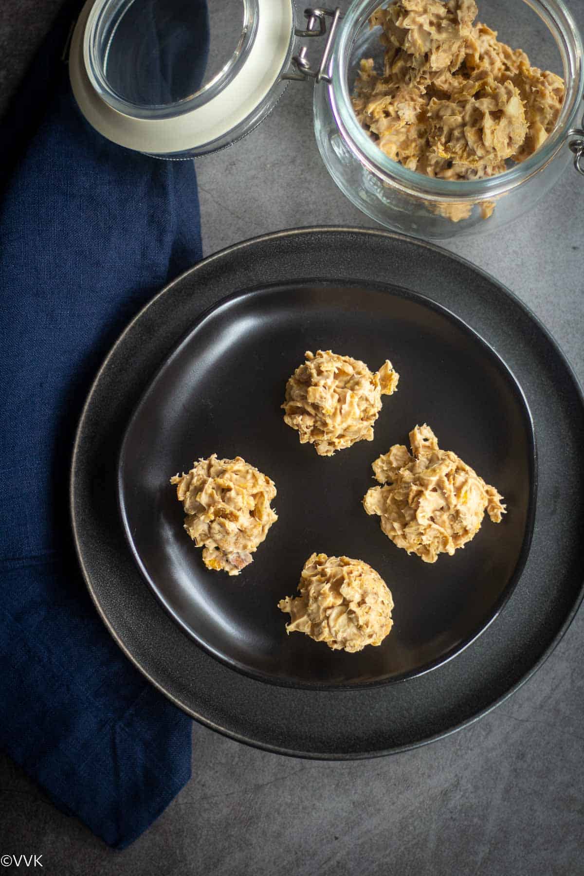 overehead shot of corn flakes cereal clusters placed on black plate