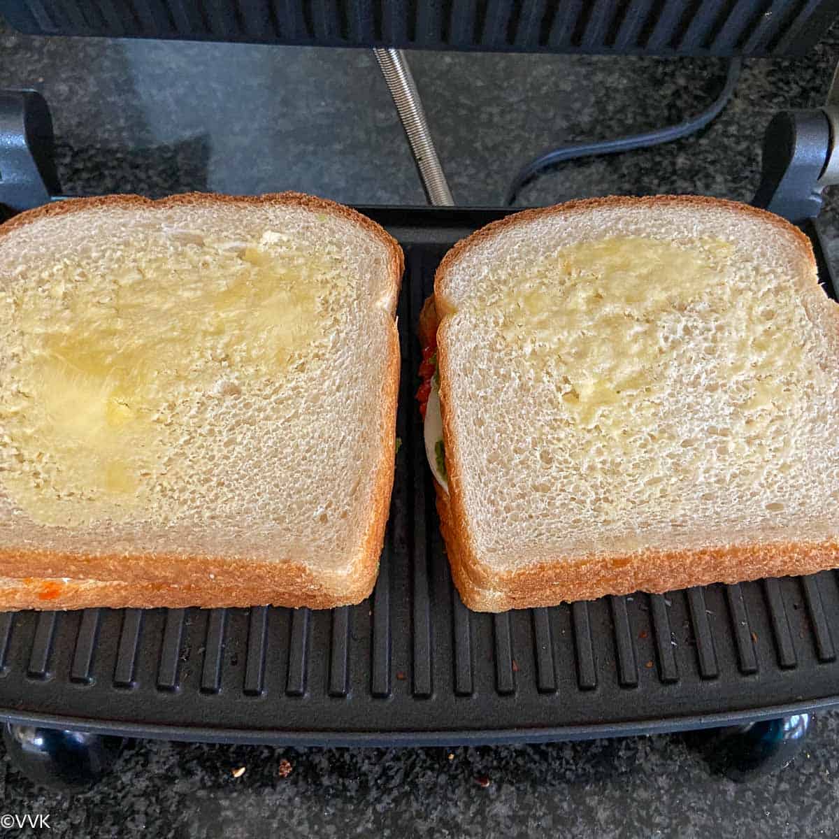 closing the sandwich and spreading butter