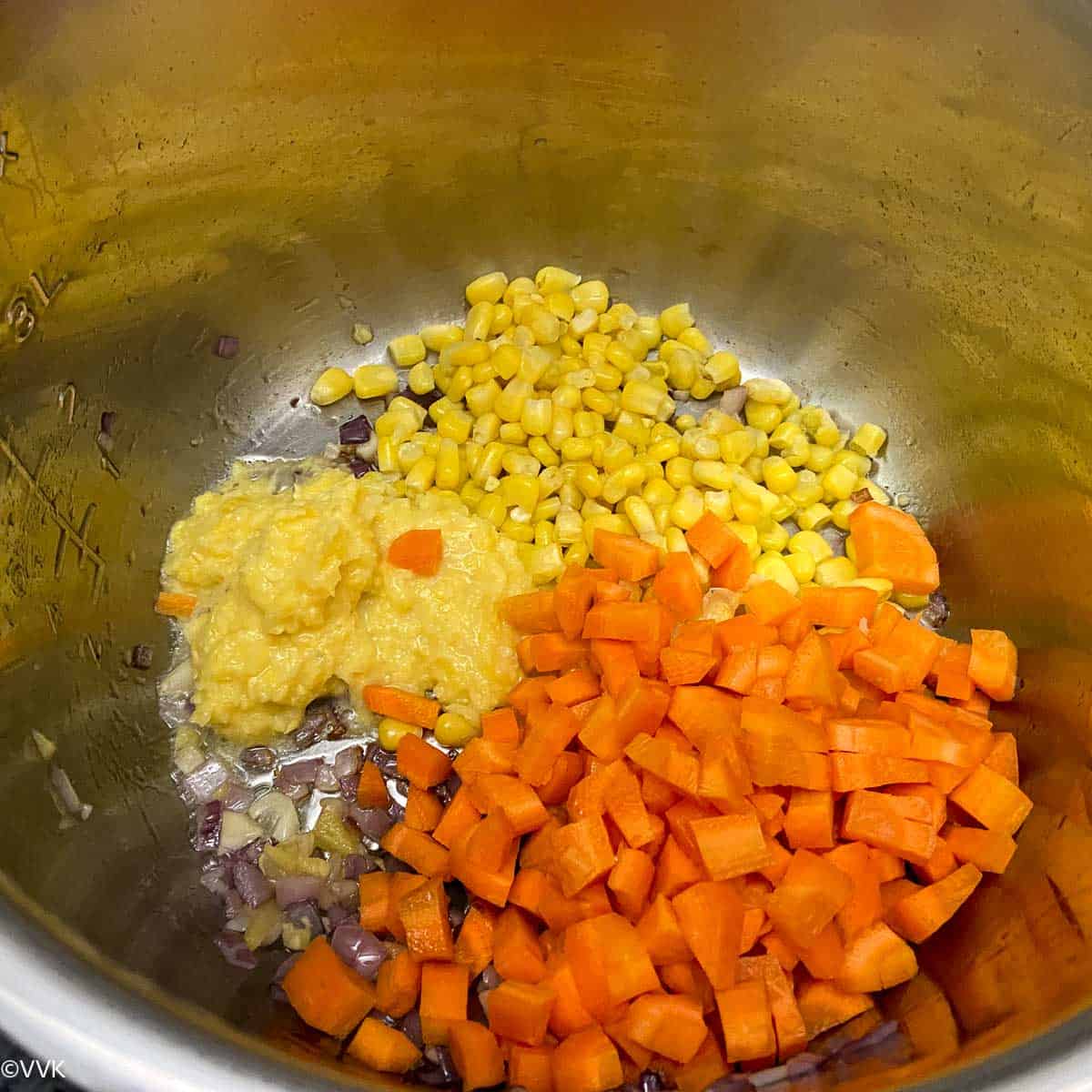 adding the corn and carrots