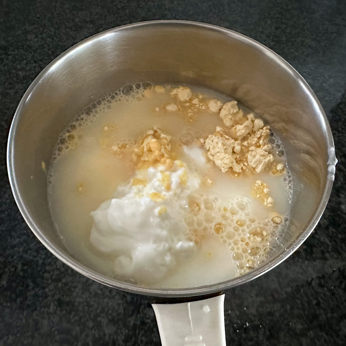 adding yogurt and besan to a blender