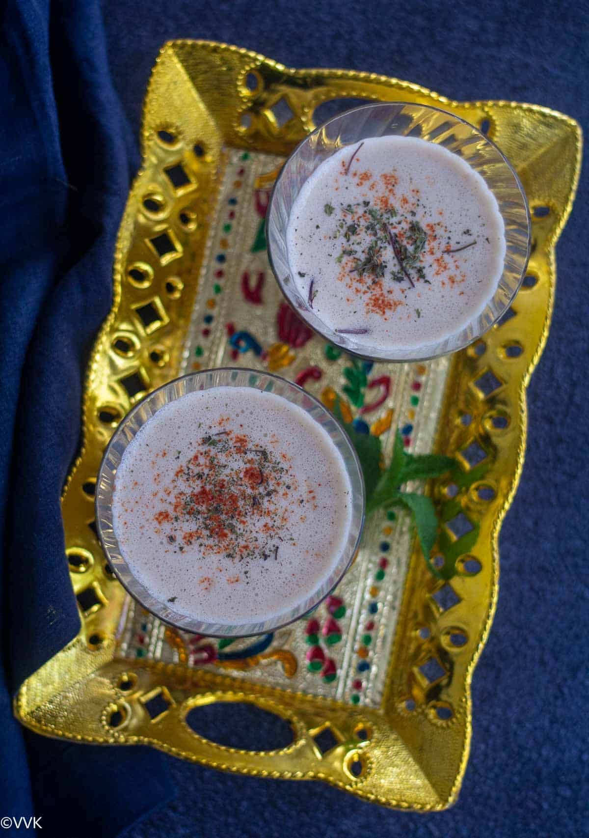 overhead shot of lassi served in two glasses