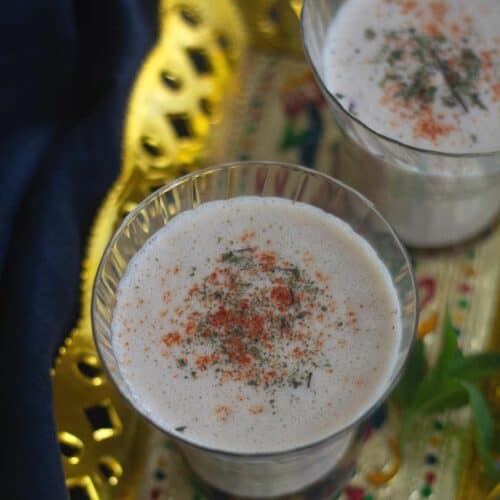 square image of spicy lassi served on golden tray
