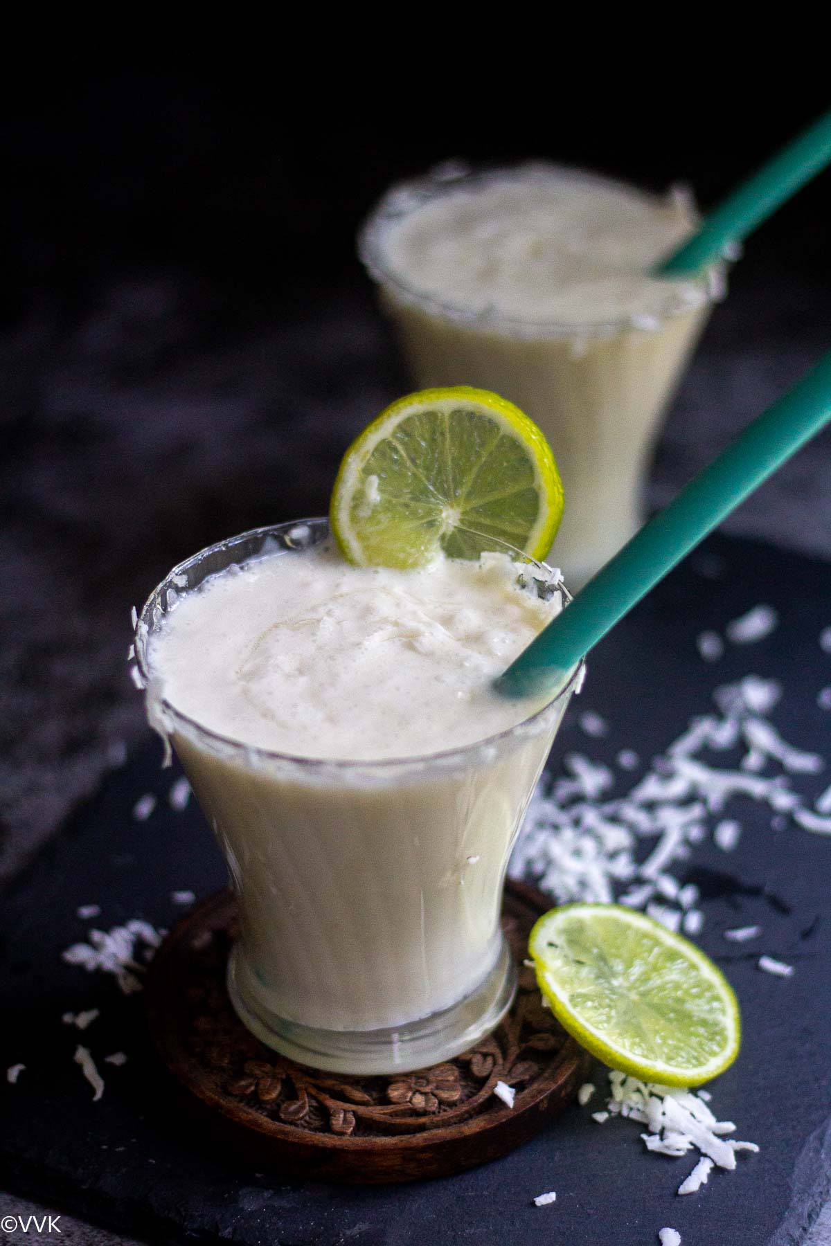 close up shot of coconut milk limeade with straw inside