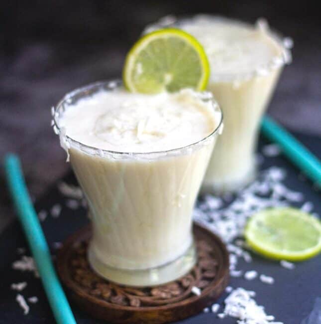 coconut milk limeade served in round glass with lime wedge on top