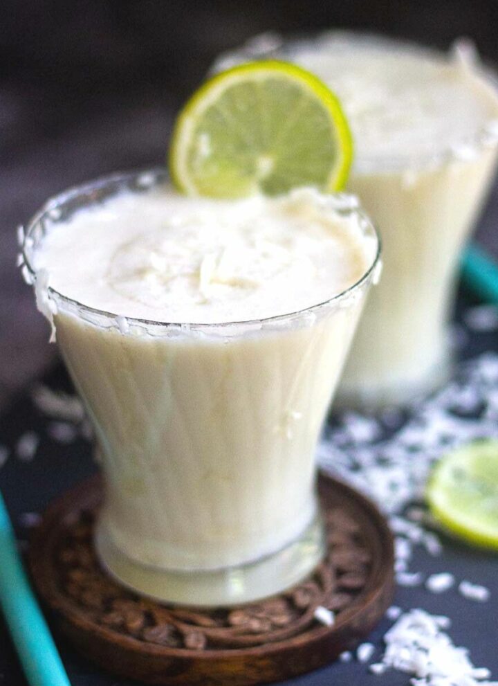 coconut milk limeade served in round glass with lime wedge on top