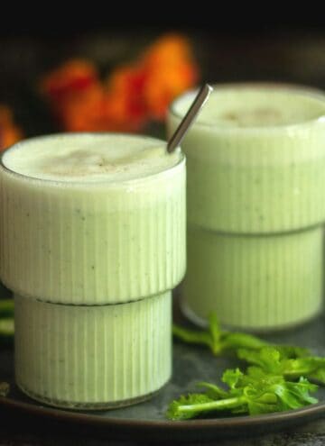 square image of cucumber lassi served in two glasses