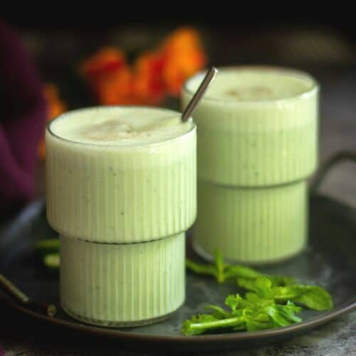 square image of cucumber lassi served in two glasses