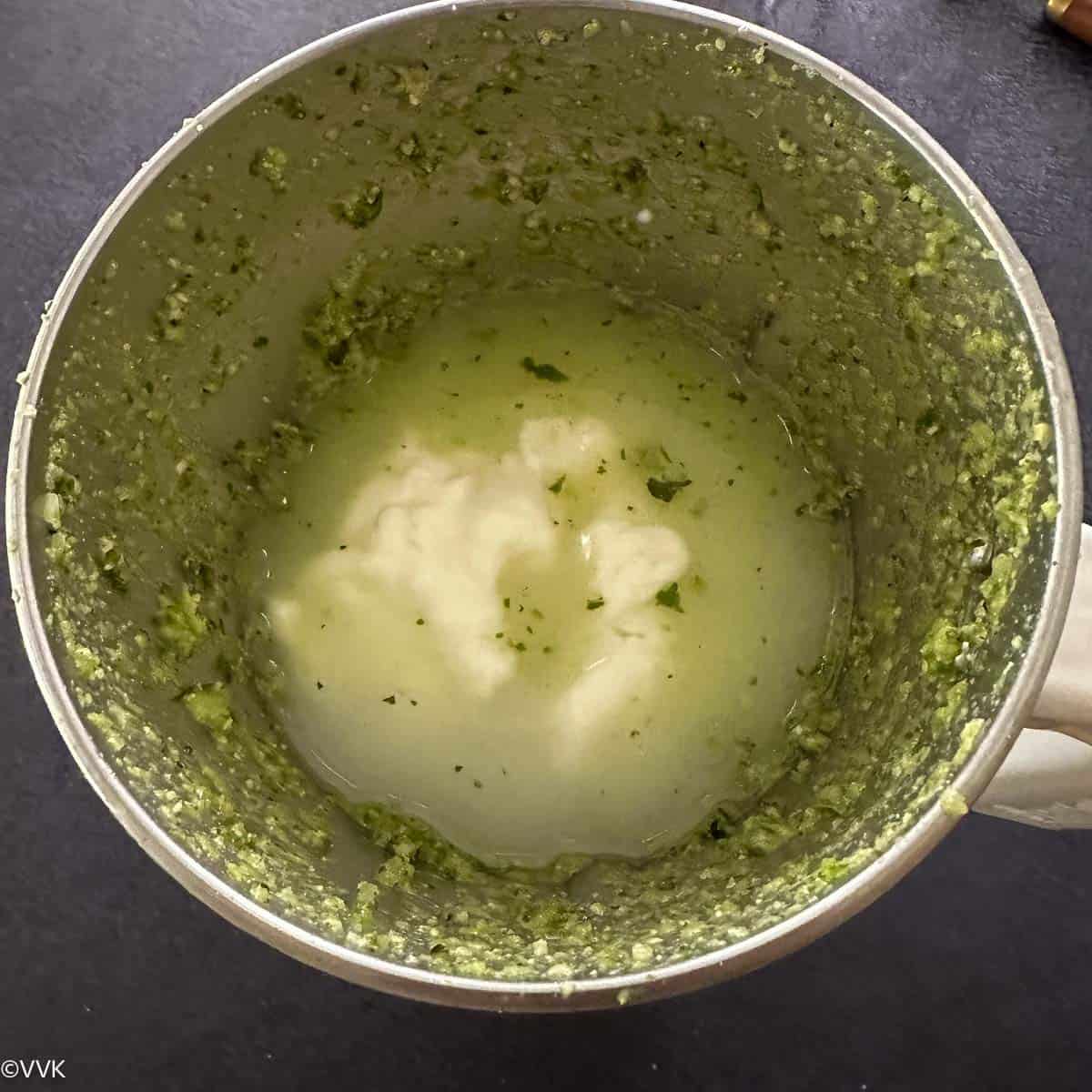 adding yogurt, salt and water to the ground herb cucumber mix