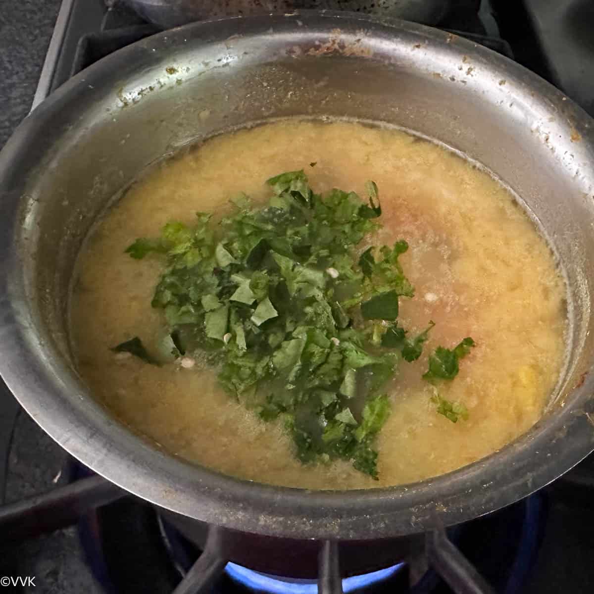 adding salt and herbs to the moong dal