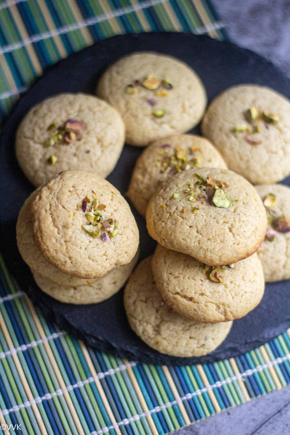 overhead shot of tahini cookies stacked up on a plate