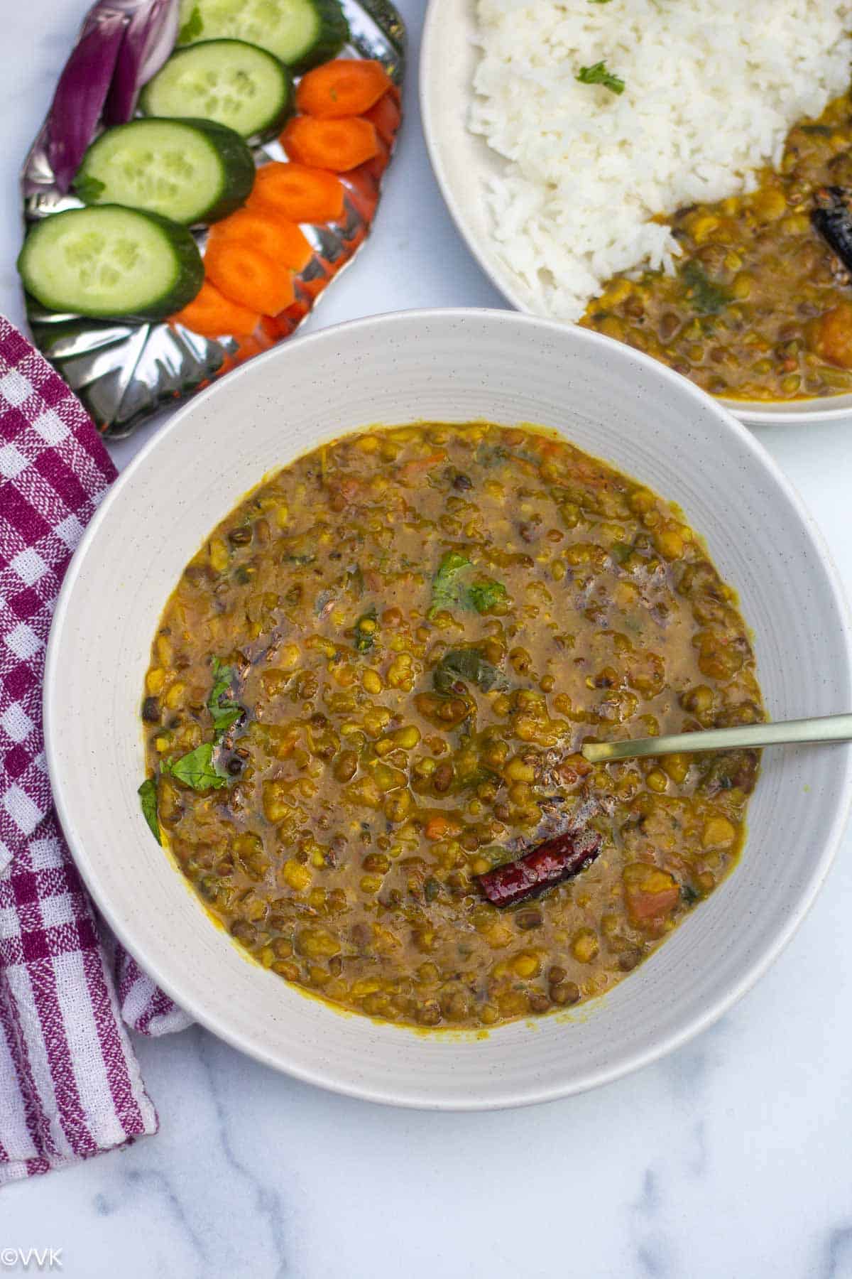 panchmel dal served with raw veggies and rice